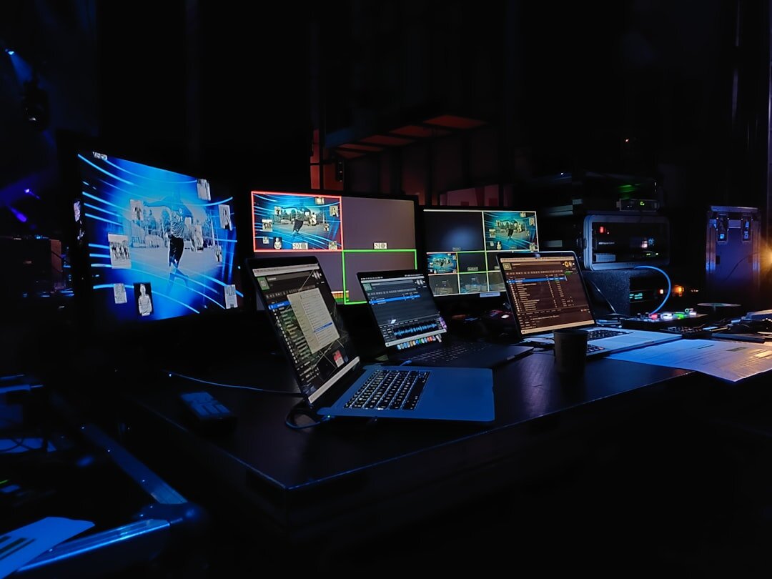 Broadcast control room with multiple video monitors and mixing console