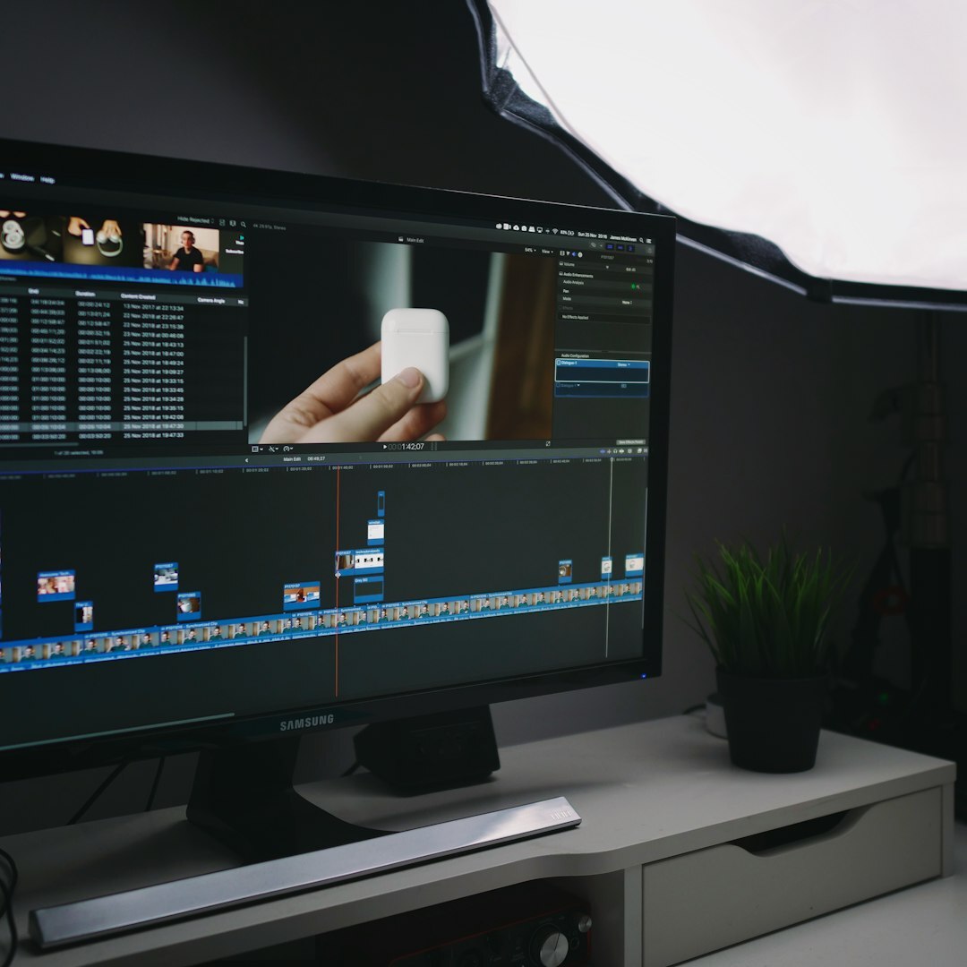 Video editor reviewing footage on multiple monitors